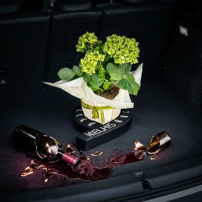 FlexiStick holding wine bottles and preventing them from rolling in trunk