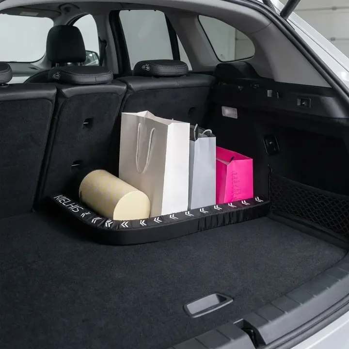 FlexiStick securing paper grocery bags in the car trunk